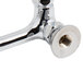 A chrome plated T&S wall mount faucet with lever handles.