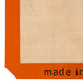 A small orange square with the words "made in Italy" on a white surface.