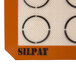 A white Sasa Demarle SILPAT® baking mat with black circles.