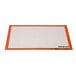 A white and orange Sasa Demarle SILPAT baking mat with a white border.