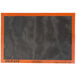 A black and orange Sasa Demarle silicone baking mat with perforations.