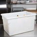 A white plastic Cambro food storage container on a white counter.