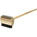 A Texas Grill Brush with a wooden handle and metal bristles.