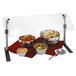 A Vollrath clear acrylic panel covering a table with bowls of vegetables, fruit, and soup.