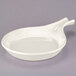 A white china fry pan server with a handle.