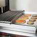 Pancakes cooking on a 24" Add-On Griddle Top over a range
