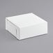 A white pie box on a gray surface.