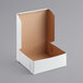 A white cardboard bakery box with a lid.