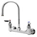 A chrome T&S wall mounted pantry faucet with two faucets and lever handles.