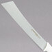 A Dexter-Russell cheese knife with a white handle.