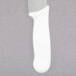 A close-up of a Dexter-Russell cheese knife with a white handle.