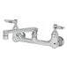 A T&S chrome wall mount faucet with lever handles and two faucets.