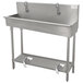 A stainless steel Advance Tabco utility sink with 6 toe operated faucets.