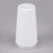 A white prefilled disposable salt shaker on a gray surface.