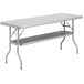 A gray rectangular Regency stainless steel folding work table with a shelf.