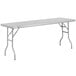 A white rectangular Regency stainless steel folding work table with legs.