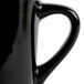 A close up of a black Libbey porcelain coffee mug with a handle.