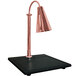 A Hanson Heat Lamps bright copper lamp on a synthetic black granite surface.