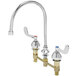 A chrome T&S medical faucet with curved wrist action handles.