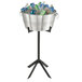 A Vollrath double wall beverage bucket on a stand with ice and drinks.