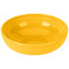 A yellow Fiesta china bistro bowl with a curved surface and lines on the bottom.