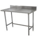 An Advance Tabco stainless steel work table with a backsplash.