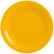 A close-up of a yellow Fiesta® Dinnerware chop plate with a white rim.