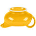 A yellow and white china sauce boat with a handle and a lid.