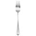 An Oneida Juilliard stainless steel table fork with a silver handle.
