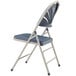 A National Public Seating gray metal folding chair with a dark blue plastic seat.