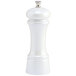 A white pepper mill with a silver top.