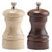 A close-up of a Chef Specialties walnut pepper mill with a wooden handle.