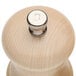 A wooden pepper mill and a natural maple salt mill with silver knobs on a wood surface.