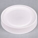 A white plastic cap for a Carlisle Store 'N Pour container.
