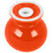 A red ceramic salt shaker with a white lid.