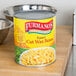 A Furmano's #10 can of wax beans on a table in a professional kitchen.