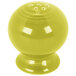 A yellow Fiesta pepper shaker with holes.