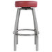 A Lancaster Table & Seating clear coat metal swivel backless bar stool with a maroon vinyl seat.