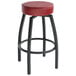 A black metal Lancaster Table & Seating swivel bar stool with a maroon seat.