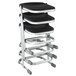 A stack of black and silver National Public Seating Z-stools with chrome legs.