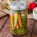 A jar of Morton Coarse Kosher Salt filled with pickles and vegetables.