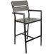 A BFM Seating black aluminum outdoor bar stool with a gray synthetic teak seat and back.