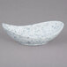 A white and blue speckled bowl with a canoe shape.