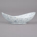 A white porcelain canoe tid bit bowl with blue speckled dots.
