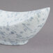 A white porcelain canoe bowl with grey speckled dots.