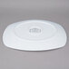 A white rectangular porcelain platter with a circular design in the center.