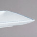 A close-up of a white rectangular porcelain platter with a small speckled design.