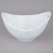 A white porcelain bowl with cut-out handles on a white background.