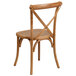 A Flash Furniture oak wood banquet chair with a cross back and white cushion.