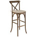 A Flash Furniture wooden barstool with a tan cushion.